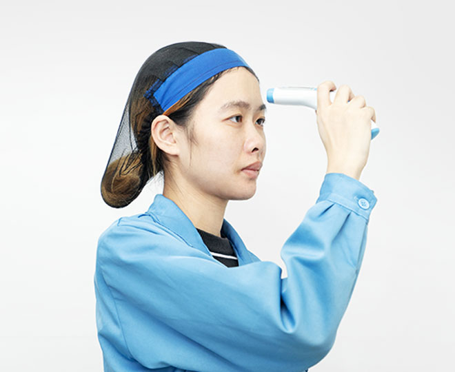 a female worker is testing a thermometer 's function