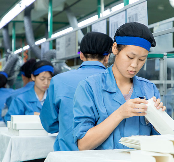 the thermometer assembly line with several workers working