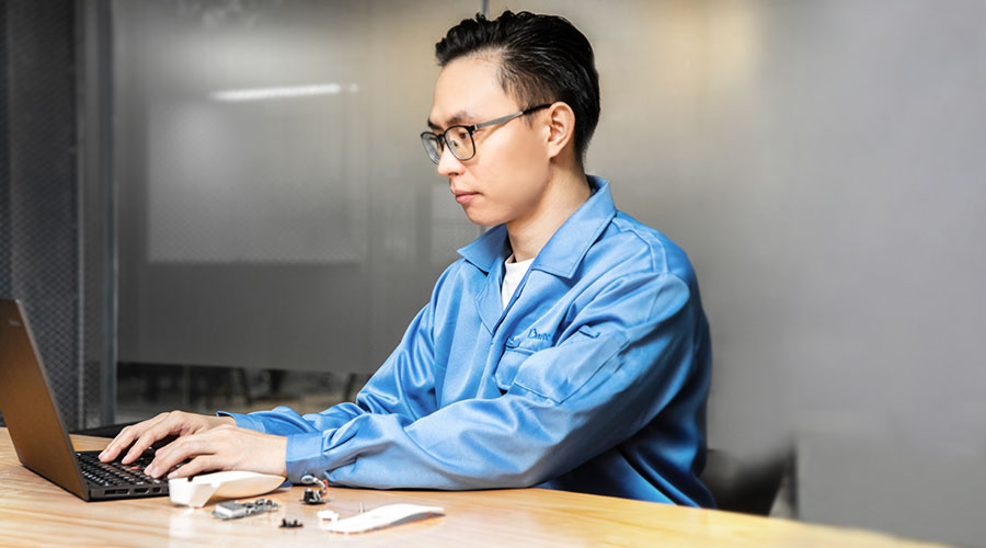 an engineer in blue suit working with a computer